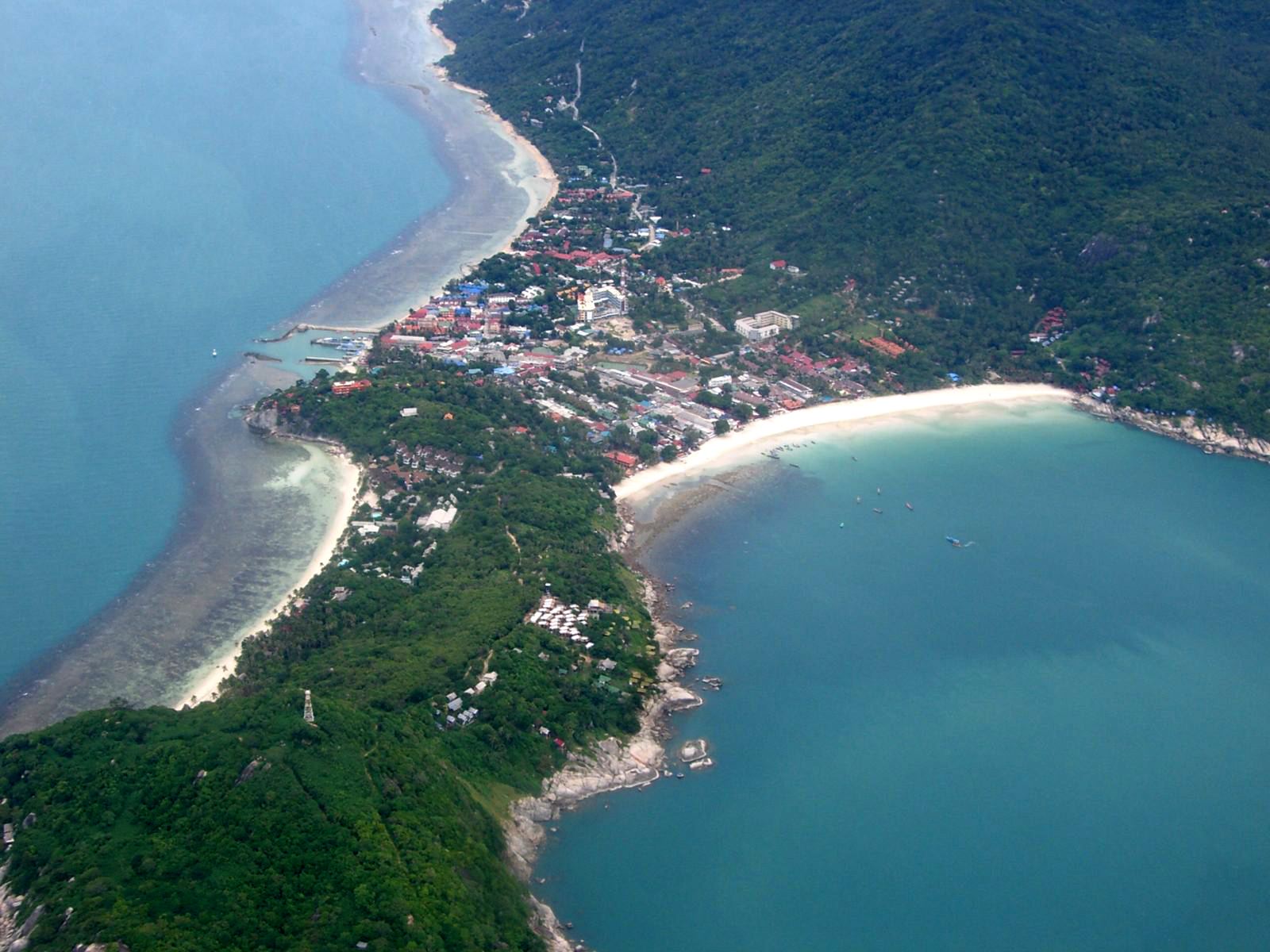 Aerial view of the Haad Rin peninsula on Koh Phangan, with the pier on the western shore and Sunrise Beach to the east