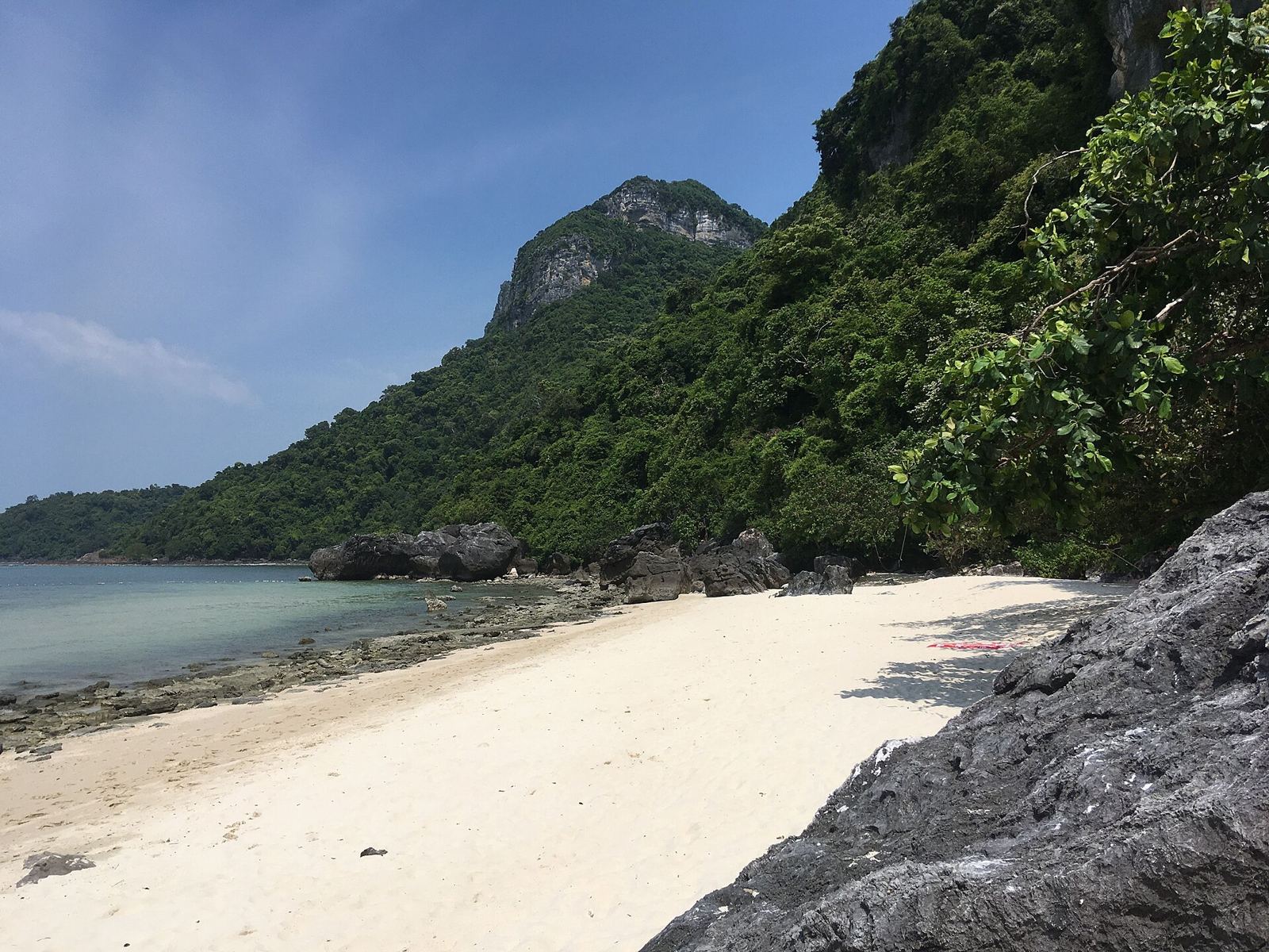 Pale sand beach on Ko Wua Talap, the park headquarters island of Ang Thong National Park, with calm clear water